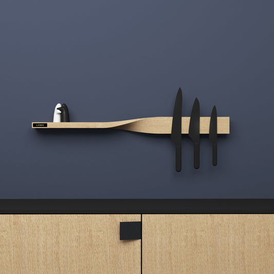 Oak shelf that twists into a magnetic knife rack, on a blue wall