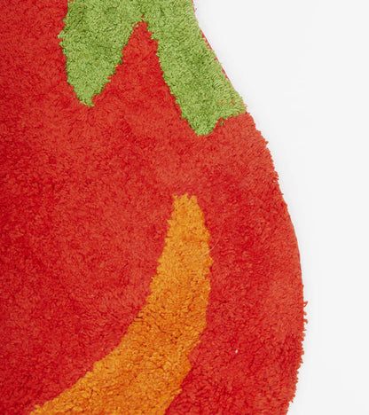 Tomato rug in red, close-up detail of the green stalk in the corner