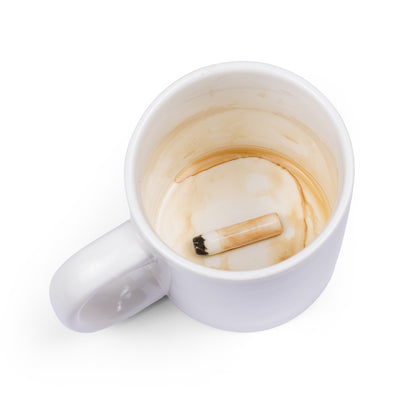The mug seen from above, empty, with the ceramic cigarette at the bottom