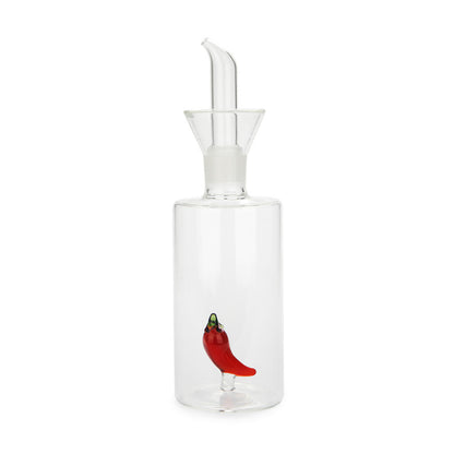 Oliera in vetro trasparente con beccuccio e un peperoncino rosso dentro, su bianco