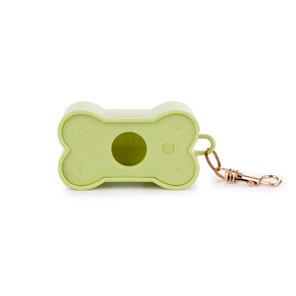 Green Biscuit dog waste bag holder, with the light-blue bag visible through the opening