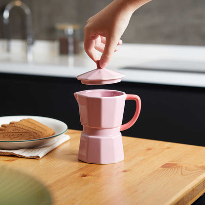 Pink Moka Mug, a hand lifting the lid off the mug