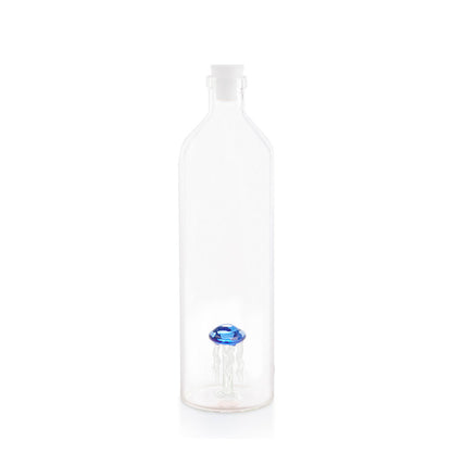 Tall clear bottle with a white stopper and a faceted blue shape at the bottom