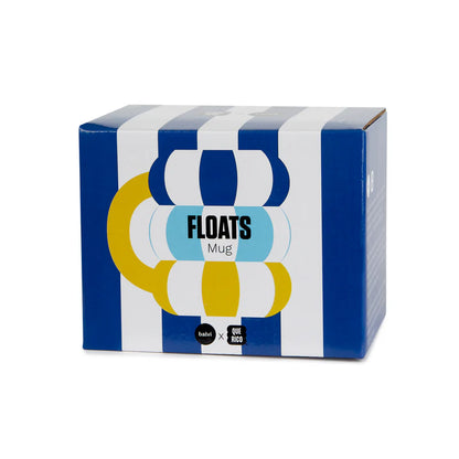 The striped mug shown in its blue and white box