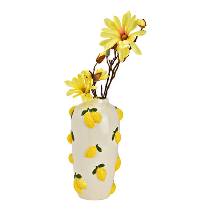 The Limonaia vase with yellow star-shaped flowers rising from the opening.