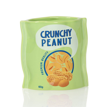 Crunchy Peanut vase in green shaped like a snack bag, printed with a peanut illustration.