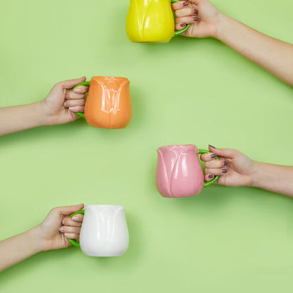 Yellow, orange, pink and white Tulip mugs held up by four people