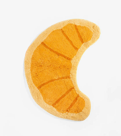 Orange croissant-shaped rug, on a white background