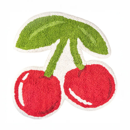 Rug shaped like two red cherries with a green leaf, on a white background