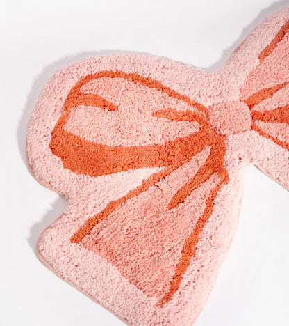 Soft bow rug in pink, close-up on the soft texture of the bow