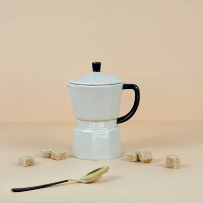 Grey Moka Mug on a beige background with a gold teaspoon and brown sugar cubes