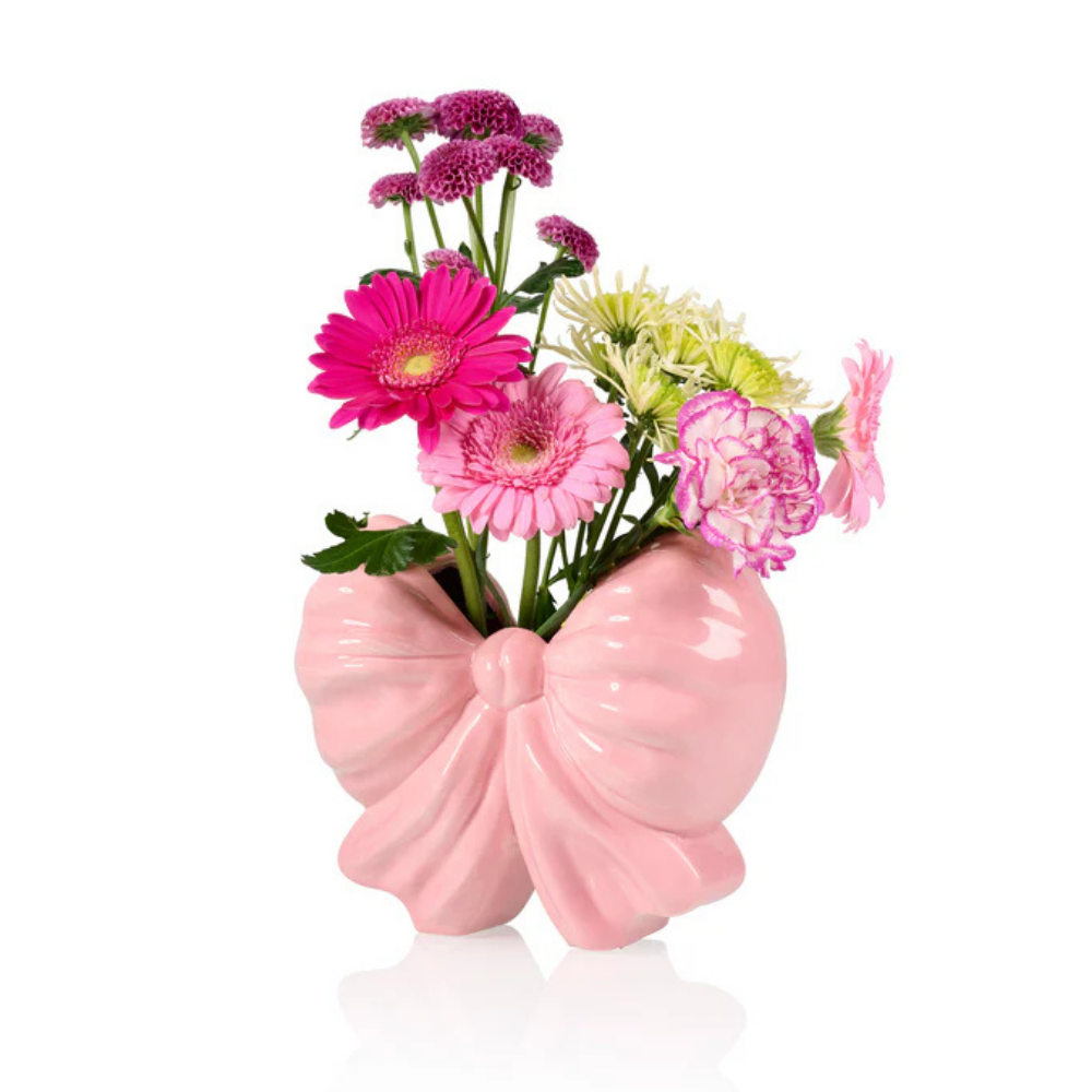 Fiocco bow-shaped vase isolated on white, with daisies and colourful carnations.