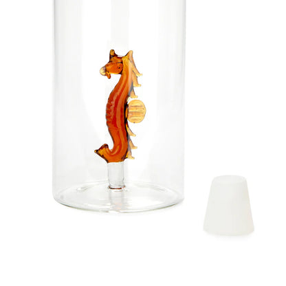 Atlantis Seahorse bottle, close-up on the orange seahorse at the base