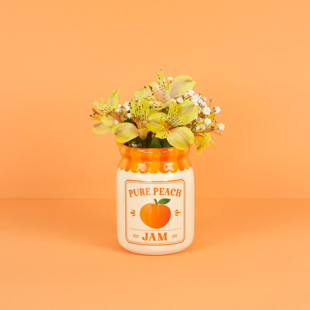Jam vase, peach version with yellow and green flowers, on an orange background