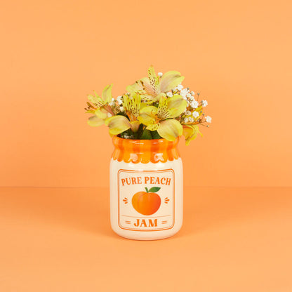 Jam vase, peach version with yellow and green flowers, on an orange background