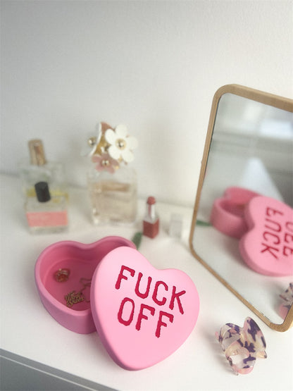 Fuck Off heart box in pink, open on a dressing table, shown from another angle.