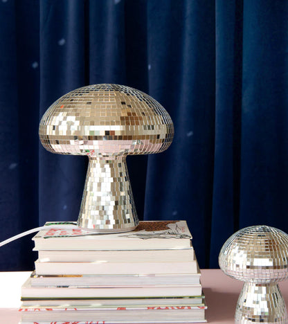 Disco mushroom lamp on a stack of magazines with a smaller version beside it