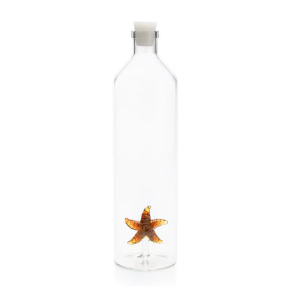Clear glass bottle with an orange starfish detail at the base