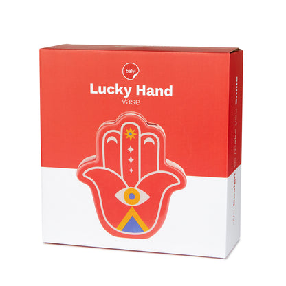 The hamsa hand vase shown in its red and white box