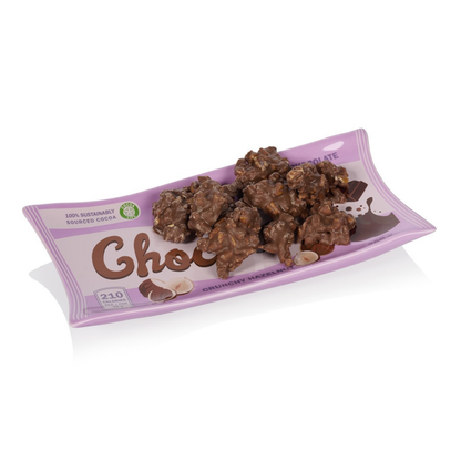 Chocolate tray in wavy purple, with chocolate truffles and hazelnuts arranged on top.