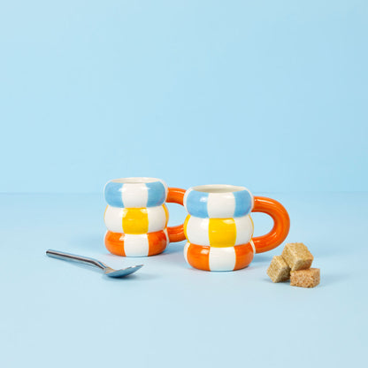 Float cup set, two mugs in blue, white and orange stripes, with a spoon and sugar cubes