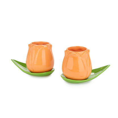 Orange Tulip coffee cup set with leaf-shaped saucers on a white background