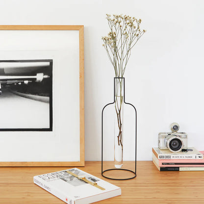 Bottle Silhouette XL vase with dried flowers on a wooden table next to a picture frame