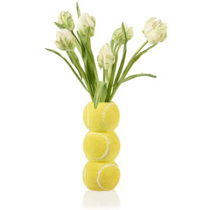 Ace Tennis Ball vase with a bunch of white tulips placed on top.