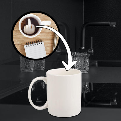 Middle Finger mug on a kitchen counter, with a close-up circle showing the finger inside the coffee.