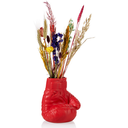 Boxing Glove vase in red, filled with colourful dried flowers.