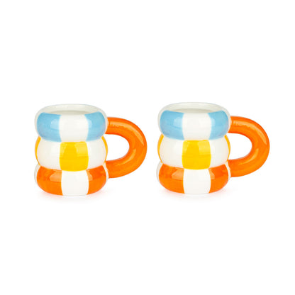 Two small mugs made of stacked blue, white, yellow and orange stripes