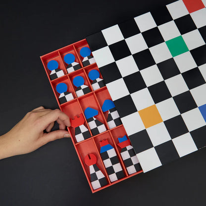 Hey Chess set with red and yellow pieces scattered across the board, seen from above.