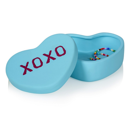 XOXO heart box in light blue, open on a white background, with colourful beads inside.