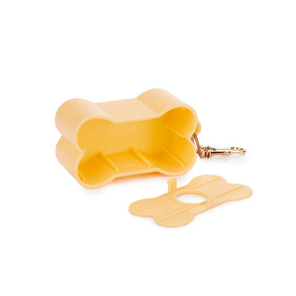 Biscuit dog poop bag dispenser shaped like a bone, open with the lid beside it