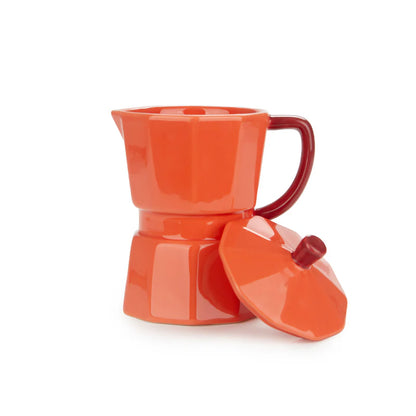Orange Moka mug filled with coffee, lid resting beside it