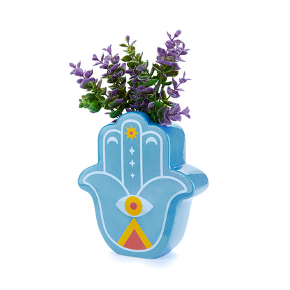 Blue Lucky Hand vase with purple leaves on a blue background