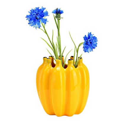 Bananas vase in yellow with a bunch of blue cornflowers placed on top.