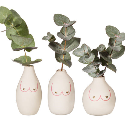 Vasi Girl Power Trio white body-shaped mini vases, each holding a sprig of eucalyptus.