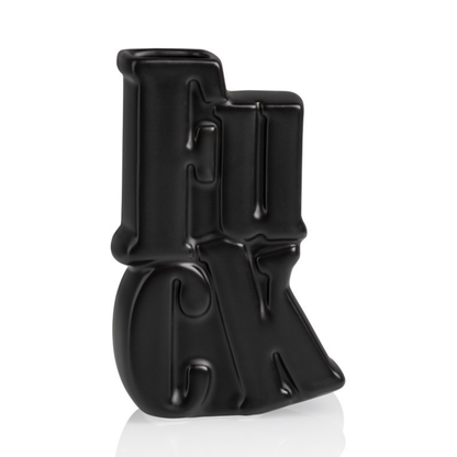 Fuck vase in matte black ceramic shaped like the word, three-quarter view on a white background.