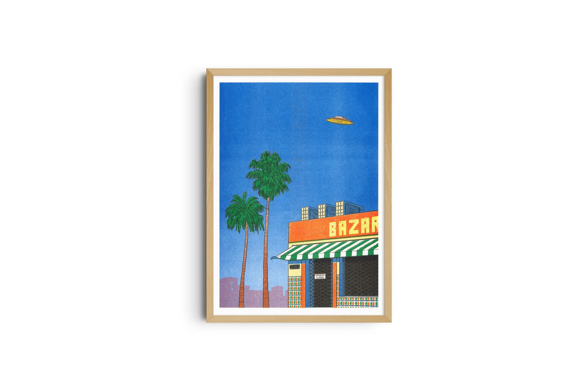Spain At 15:00 poster shown full length in a light wood frame, palm trees under a blue sky with a UFO