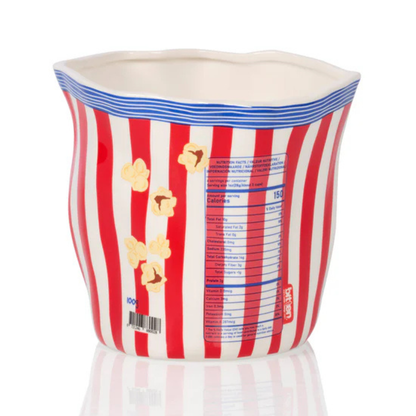 Popcorn tub vase seen from the back, printed with a nutrition table and a barcode.