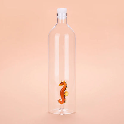 Atlantis Seahorse bottle with a white stopper, on a peach background