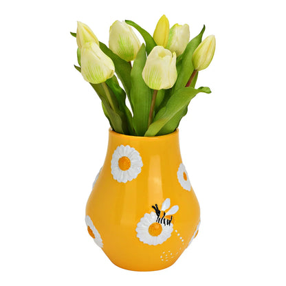 The Bee Happy vase with pale yellow tulips rising from the opening.
