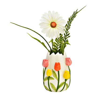 The Tulipano vase with a white daisy and a green sprig rising from the opening.