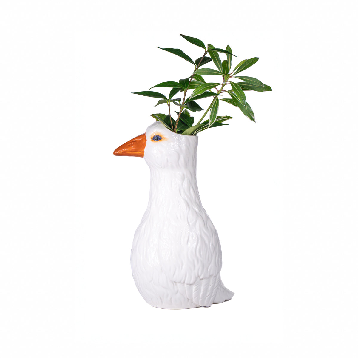 The Oca vase with a leafy green sprig growing out of the goose's head.