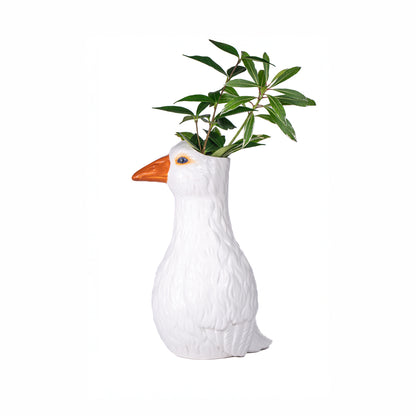The Oca vase with a leafy green sprig growing out of the goose's head.