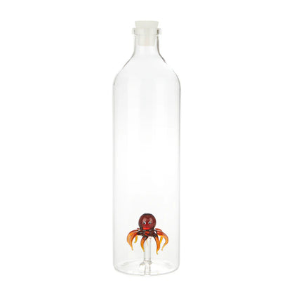 Clear glass bottle with a small red octopus detail at the base