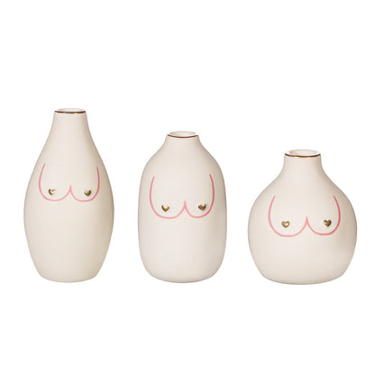 Girl Power Trio vases in white, three bud vases of different shapes with a pink bust outline and small gold hearts.