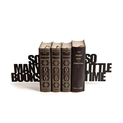 So Many! Bookend: the black lettering holding up four antique leather-bound books.