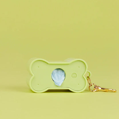 Green Biscuit dog waste bag holder, disassembled with the lid separated from the body
